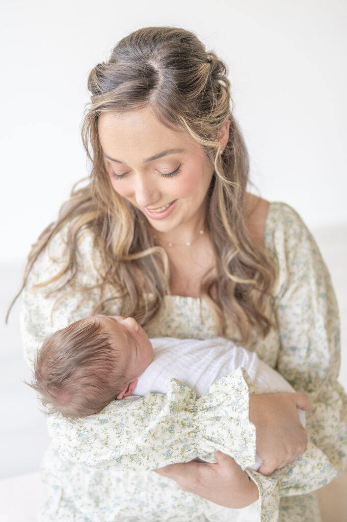 Mom looking at baby by Raleigh Newborn Photographer 