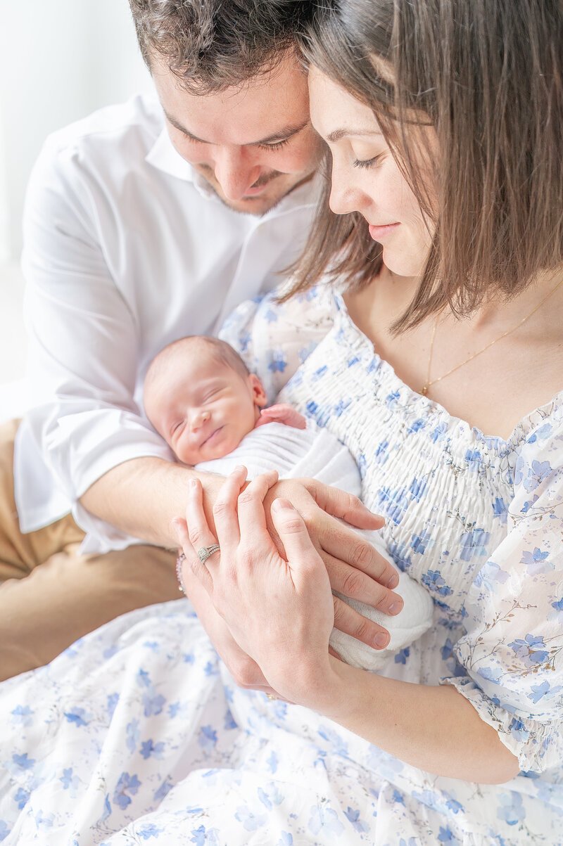 parents looking at newborn baby taken by raleigh newborn photography